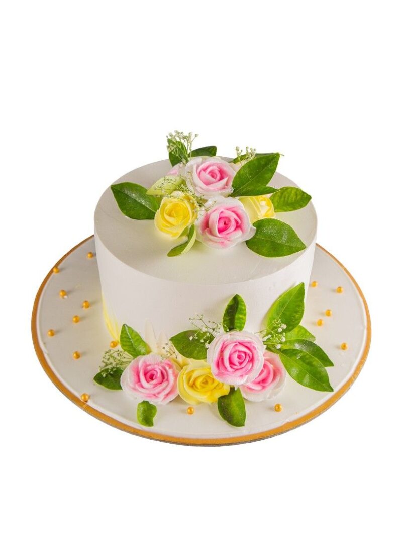 Elegant floral cake decorated with pink and yellow roses, green leaves, and golden pearls.