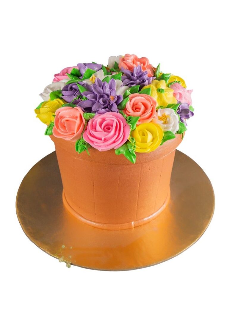 Flower vase cake designed as a pot filled with colorful buttercream roses and blossoms.